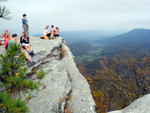 Hikers sit perilously close to the edge of McAfee Knob. Photo by Clark Norton