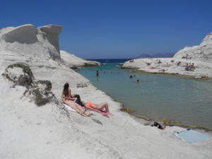 Sunbathing on the rocks at Sarakiniko. Photo by Clark Norton