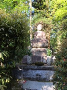 Buddha in the gardens at Ryoan-ji temple, Kyoto, Japan