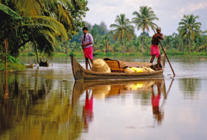 Kerala: Boatmen on backwaters crossing a lagoon. Photo by Dennis Cox/WorldViews