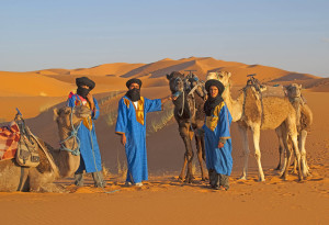 Adventure travel could be riding camels in the desert -- or taking a luxury safari in Africa. Photo by Dennis Cox/WorldViews