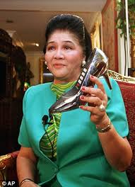 Imelda Marcos demonstrates her phone shaped like a shoe. 