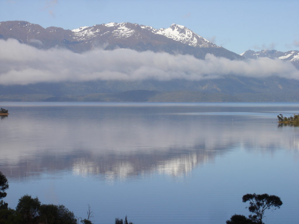 Mt. Cook rises above a tranquil lake in New Zealand. Photo by Clark Norton