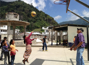 Volunteering can also mean helping kids learn basketball. Photo from Discover Corps. 